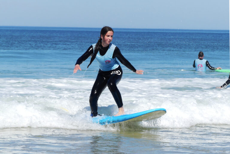 A shredder enjoying the day in the water by Ocean Lovers Surf School.