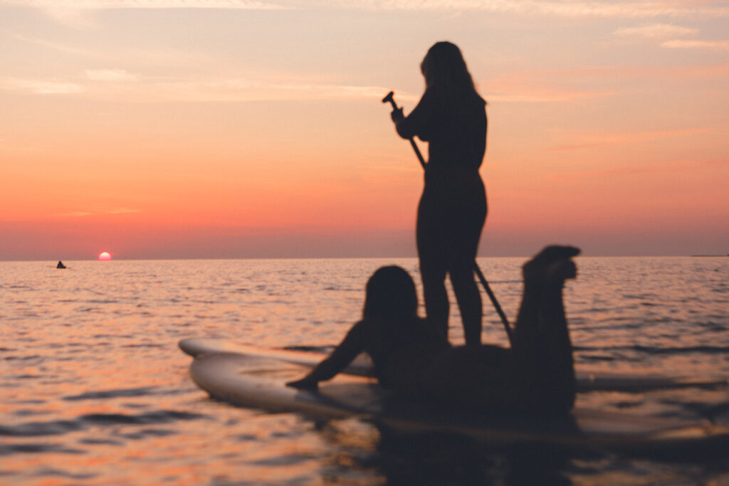 Surflogiet providing some moments for surfers to take a paddle during a perfect sunset.