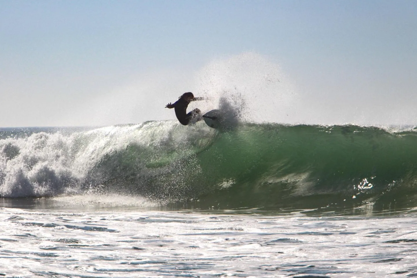 One of the crew members at Saint Girons Surf House enjoying the waves a minute walk away.