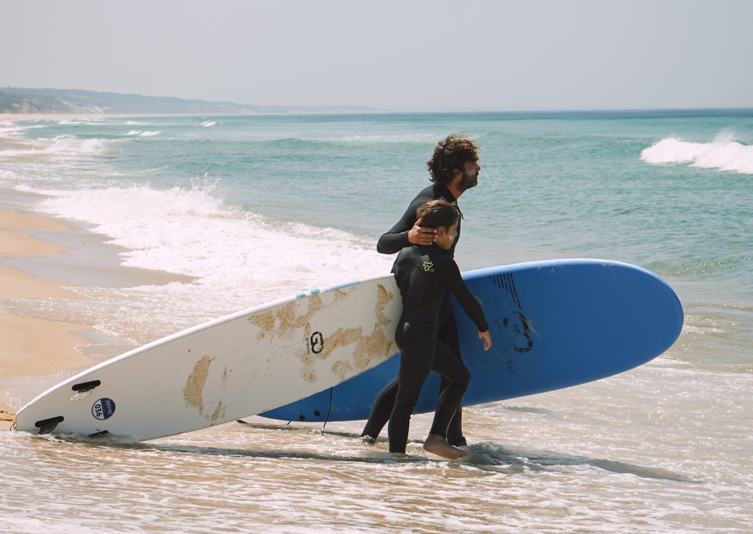 Founder and owner, Eduardo, guiding a grom into the water.