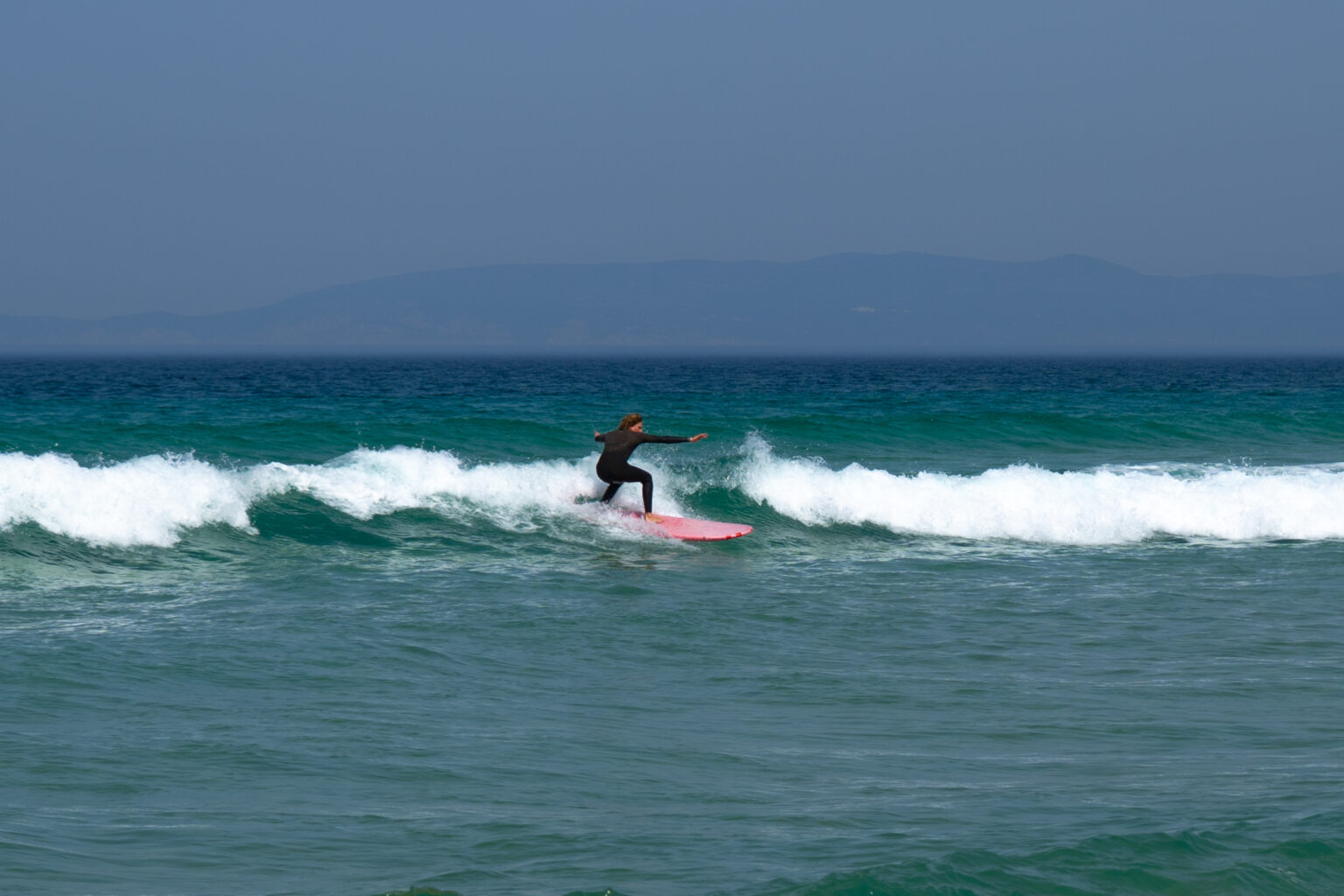A rider catching a surf wave.