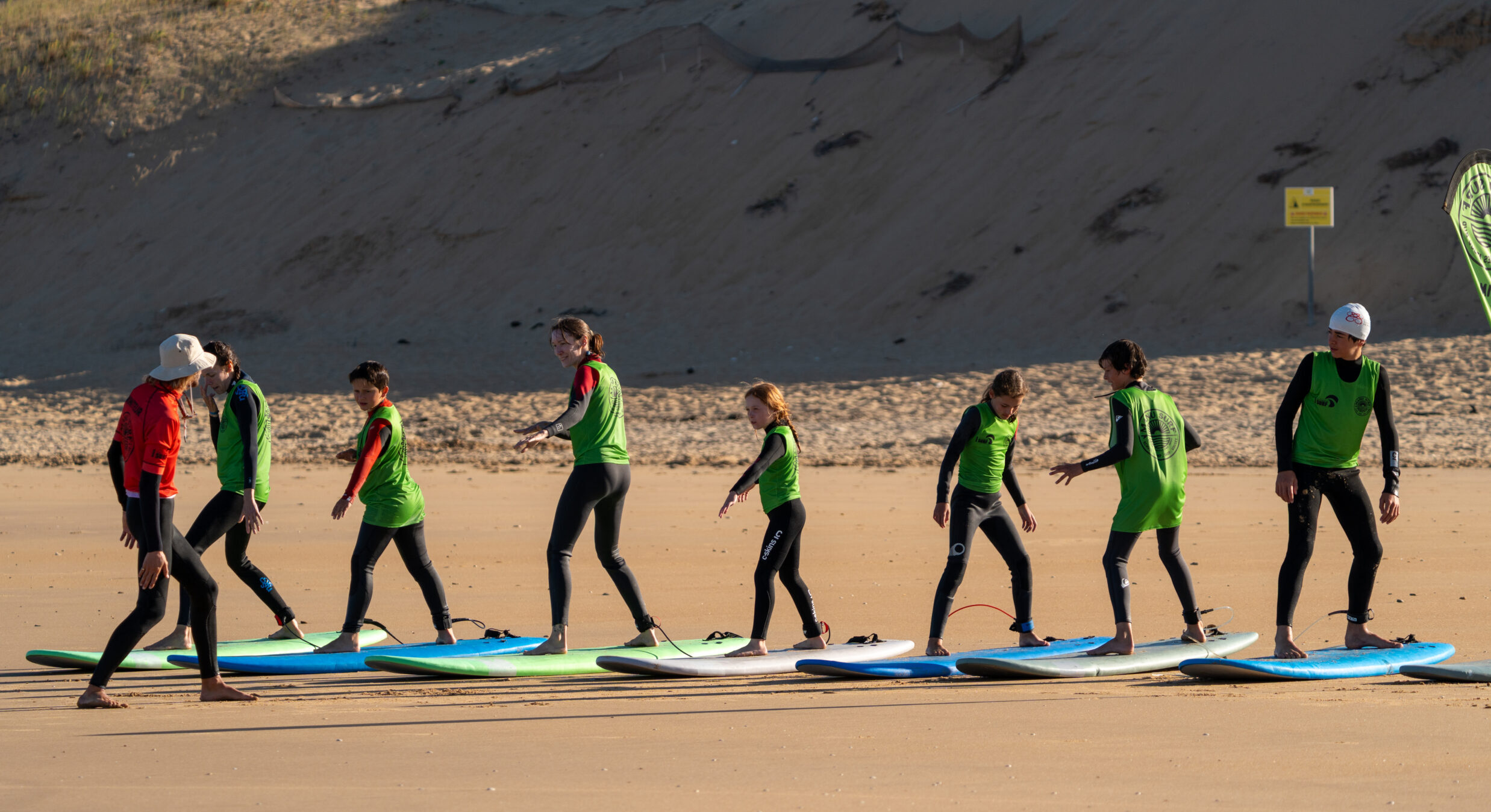 A lineup of students getting ready to hop into the water with Manu Surf.
