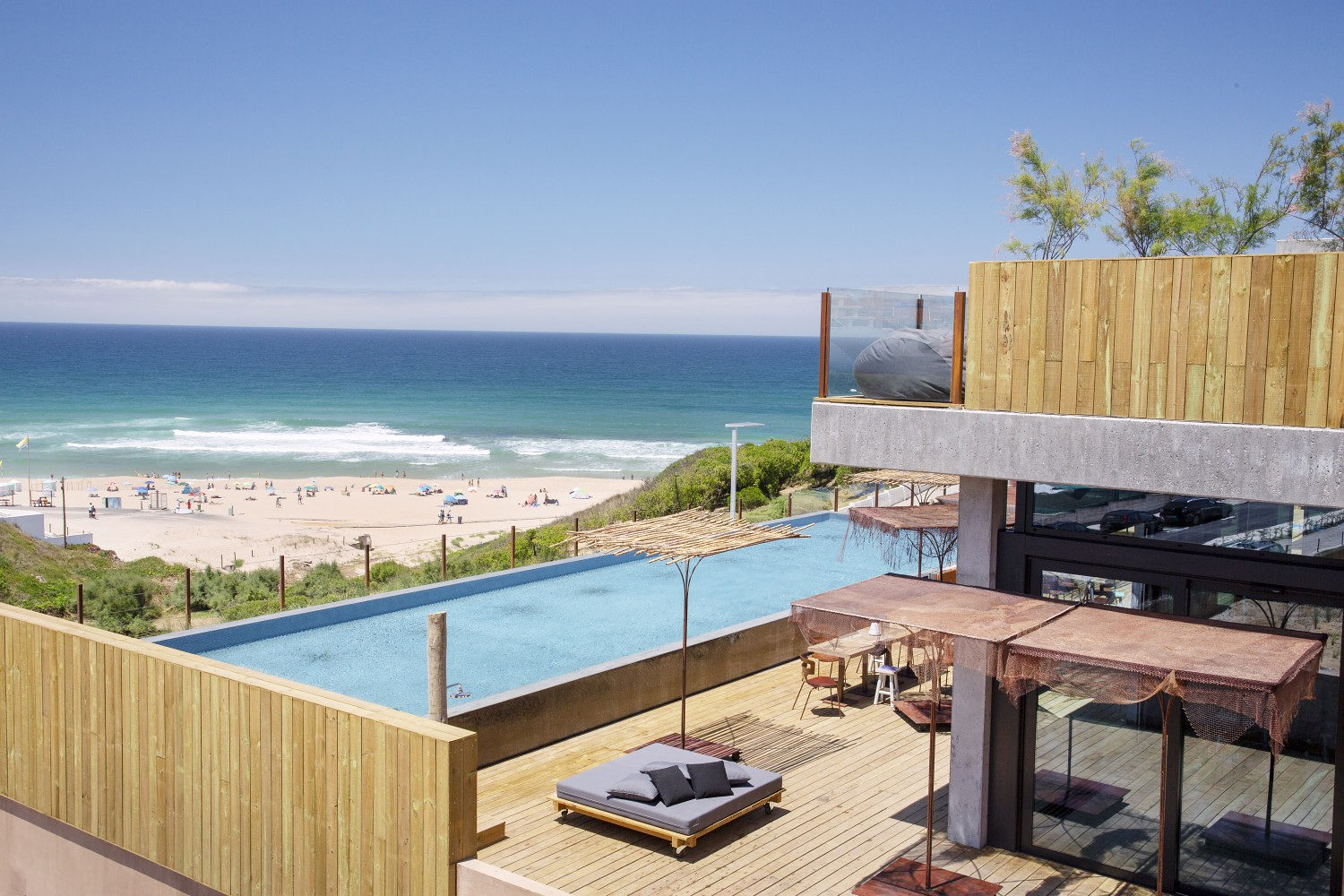 Noah Surf House sitting right alongside the coastline with view of the surf from their swimming pool!