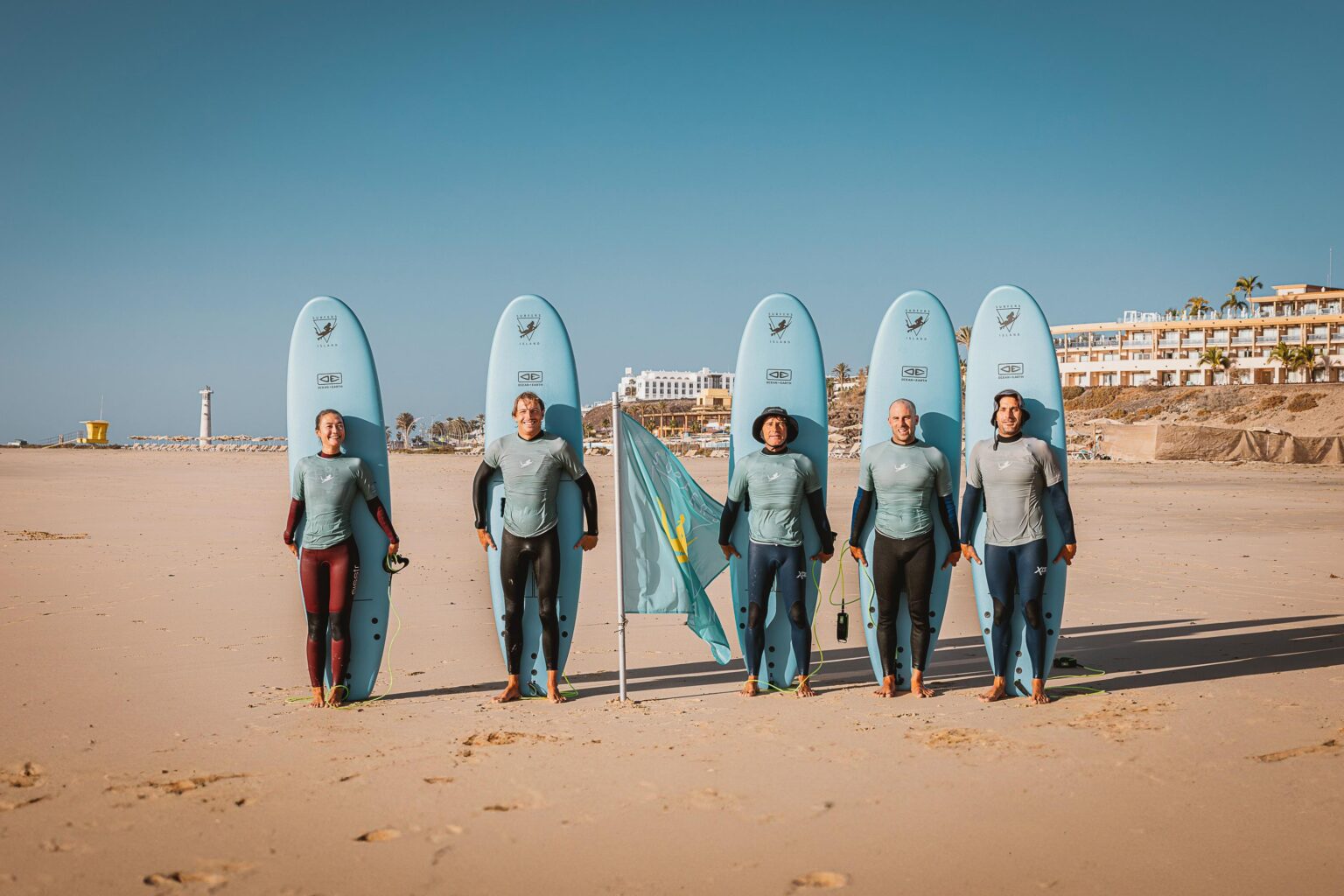The Surfers Island team standing and posing with big smiles.