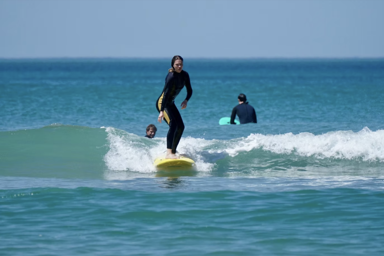 A surfer enjoying a sunny day on the coastline of Biarritz. Photo by Mad Wax Surf School.