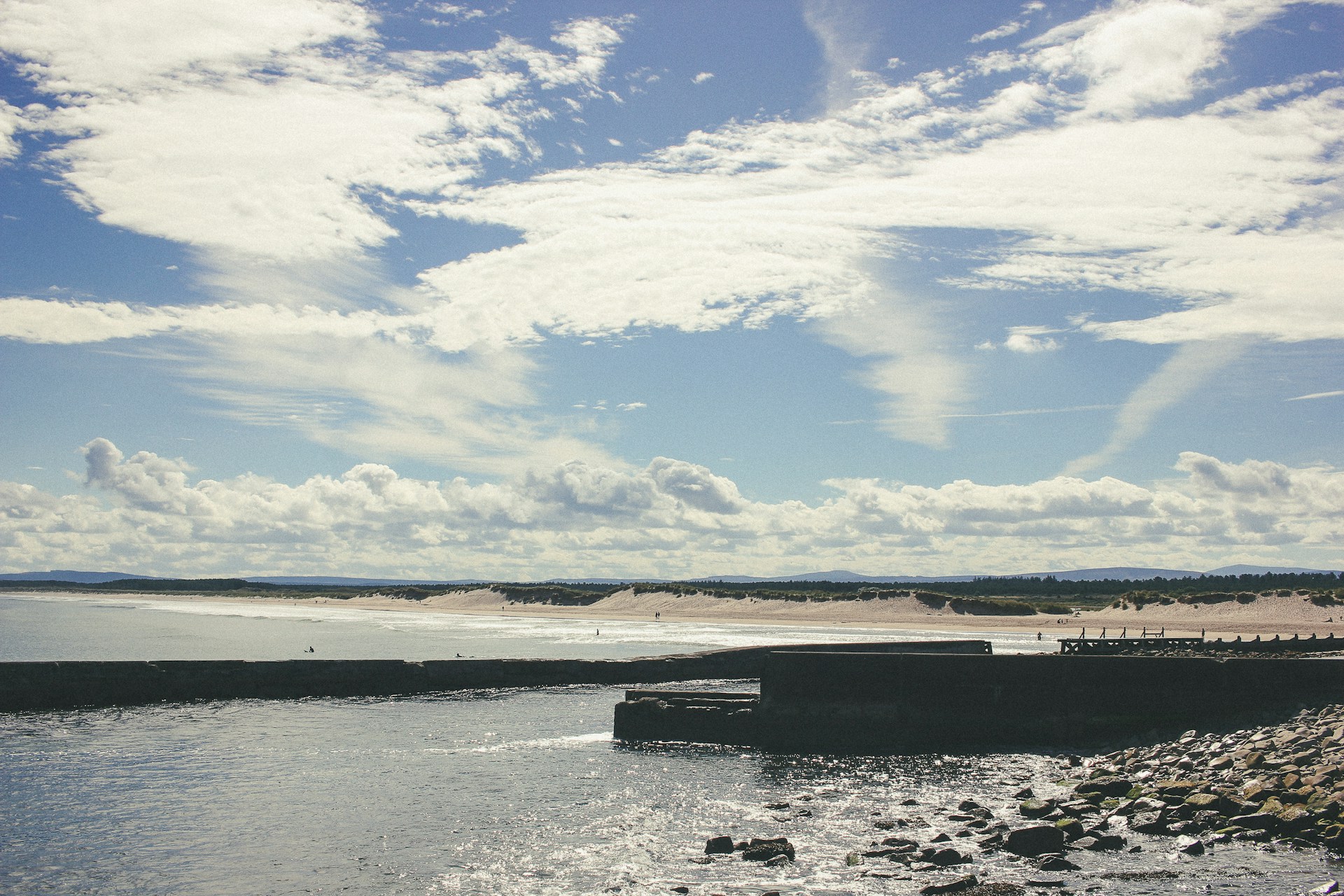 Another shot of some surfers riding waves in Lossiemouth.