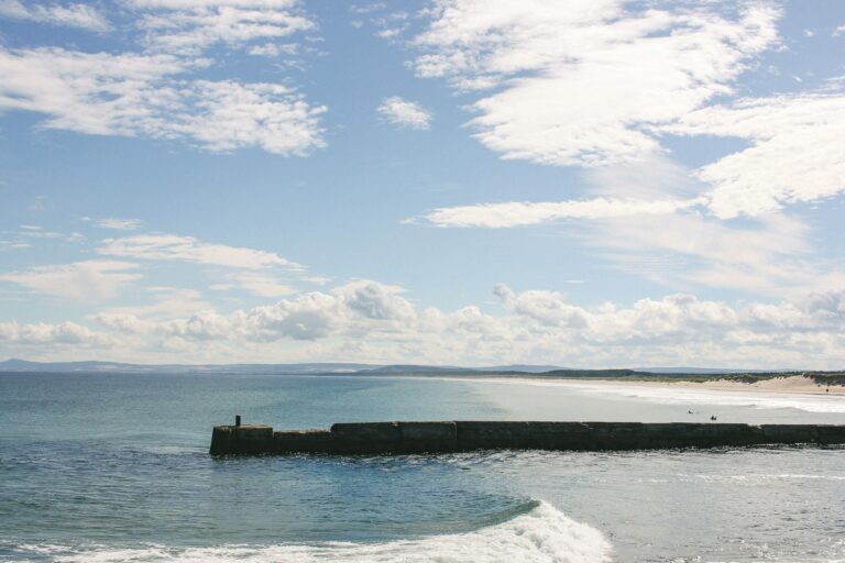 Some surfers enjoying the coastal area of Lossiemouth.
