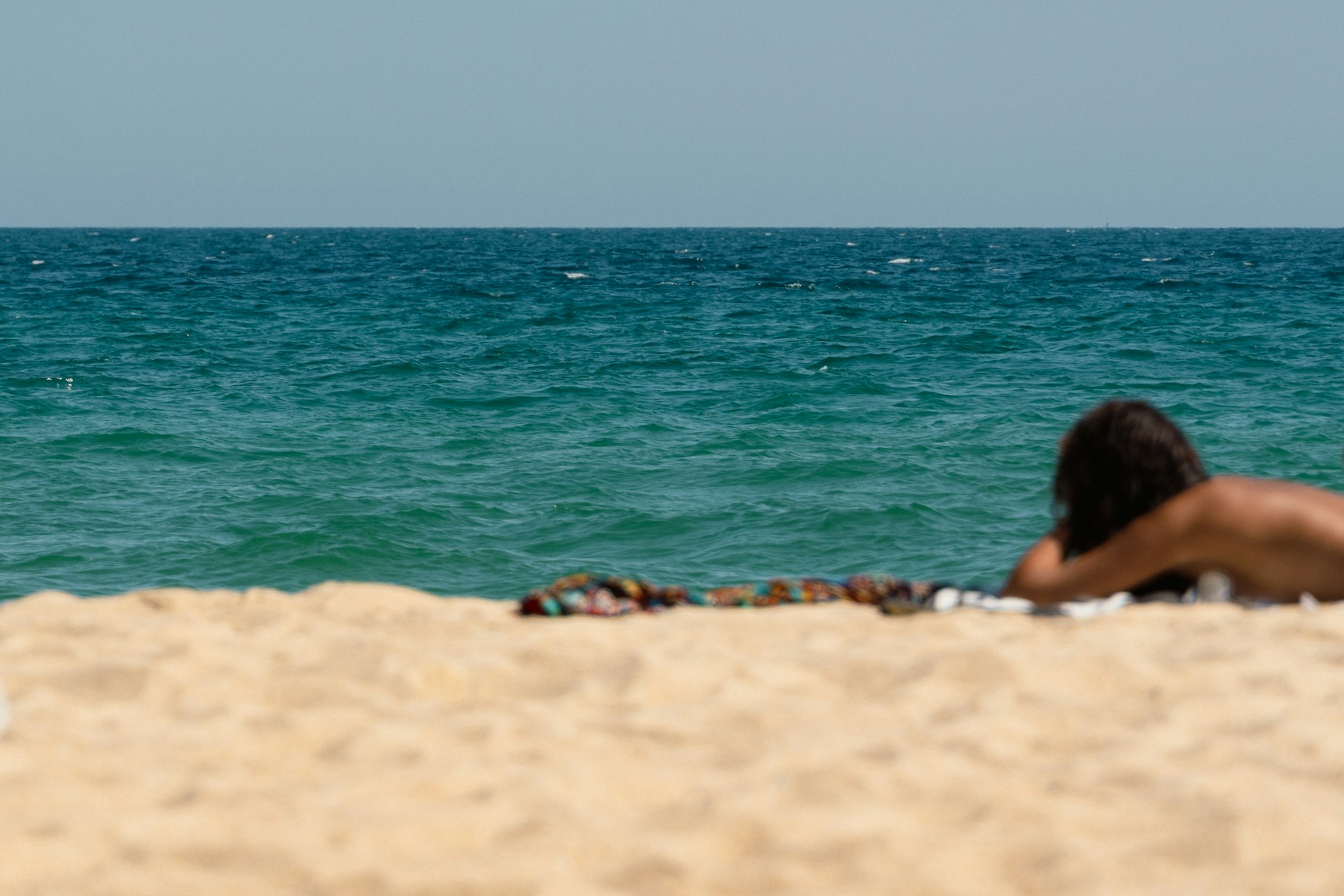 A girl enjoying the warm weather on the beach in Rota, Spain.