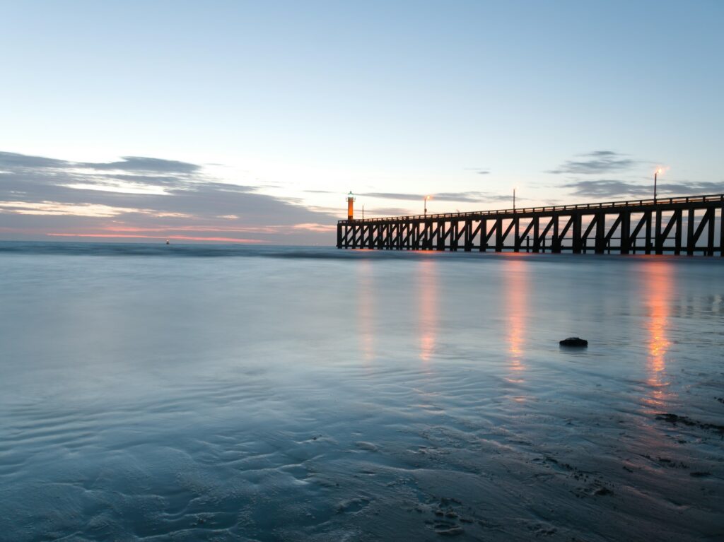 The pier at Blankenberge shining in the evening sunset.
