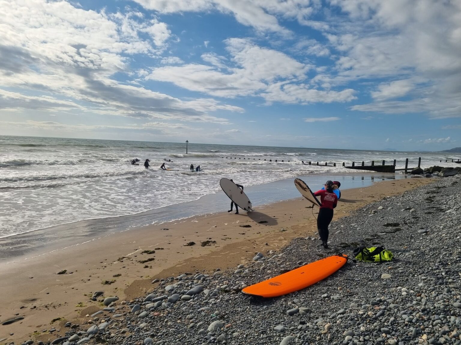 A beautiful shot of a cloudly afternoon with AberAdventures and surfing.