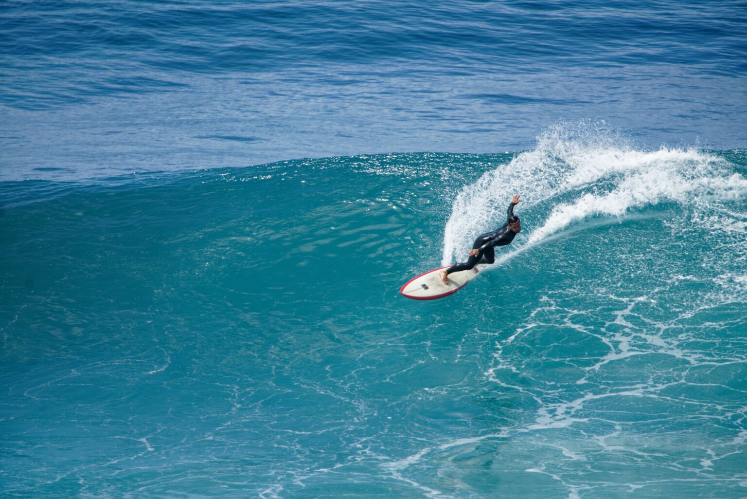 A surfer riding a wave at an undisclosed location in Madeira.