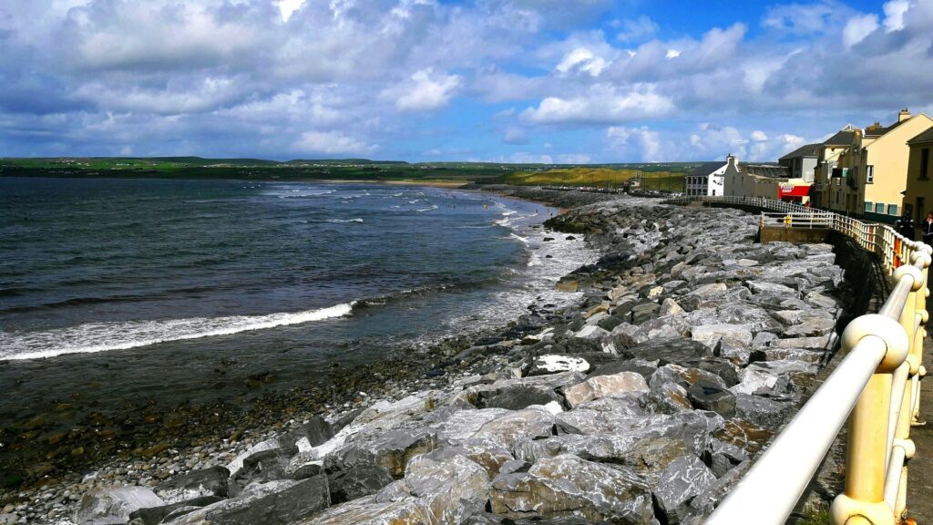 A view of Lahinch with surfers in the background.