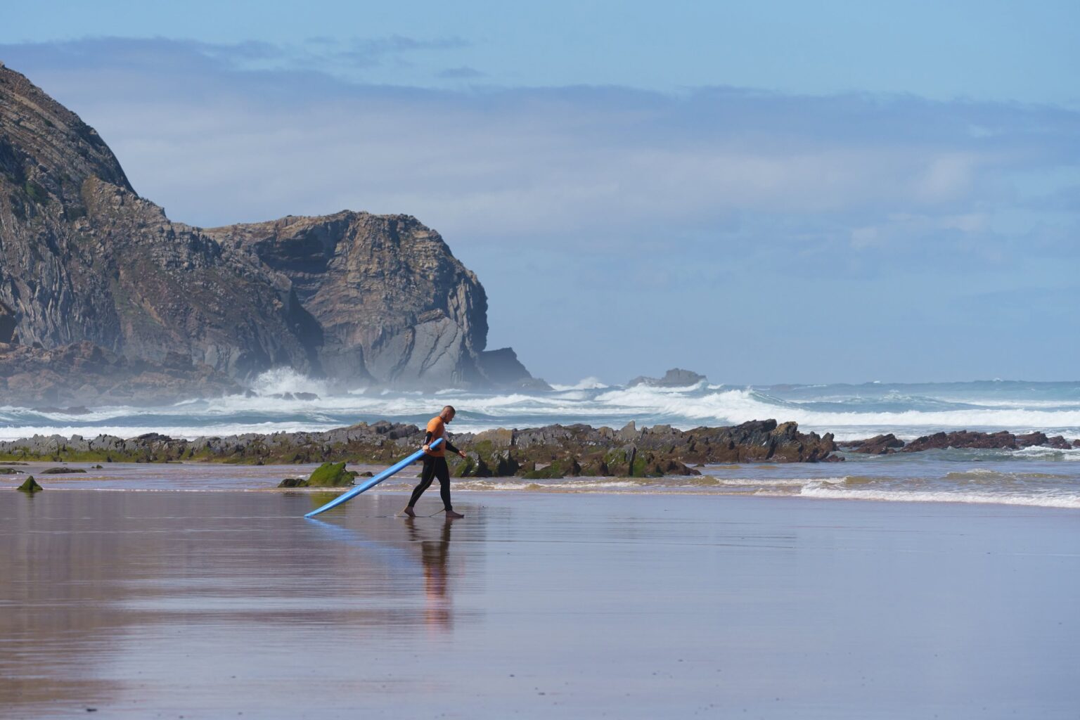 One of the students of Good Feeling Surf School taking a scenic walk out to waves on a beach in the Sagres area.