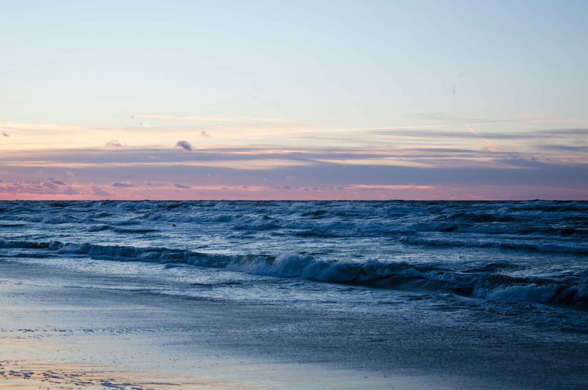 Some white chopped waves breaking during a sunset at Wladyslawowo.