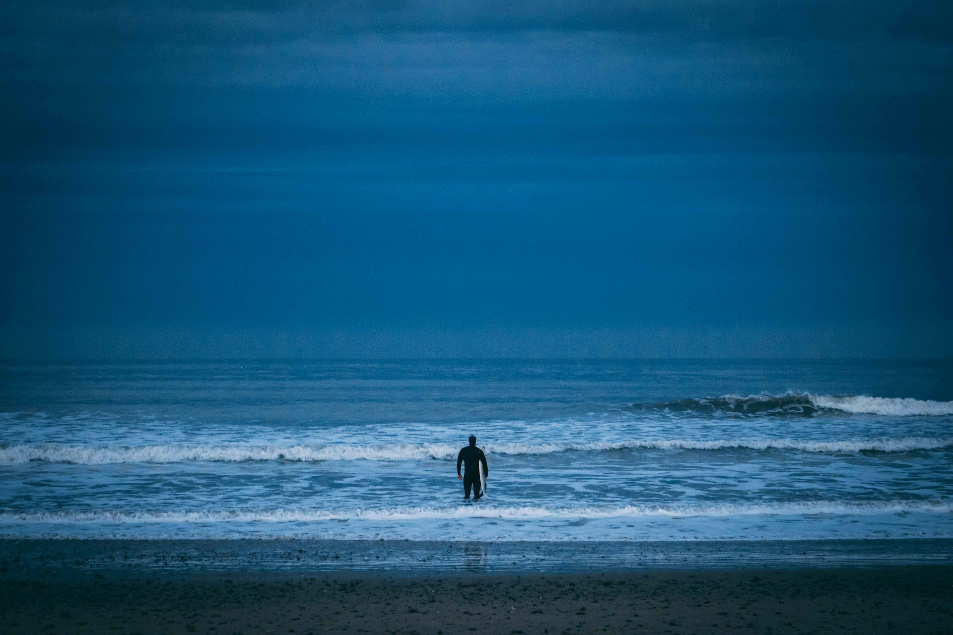 A surfer facing the cold waters in the evening at Aberdeen.