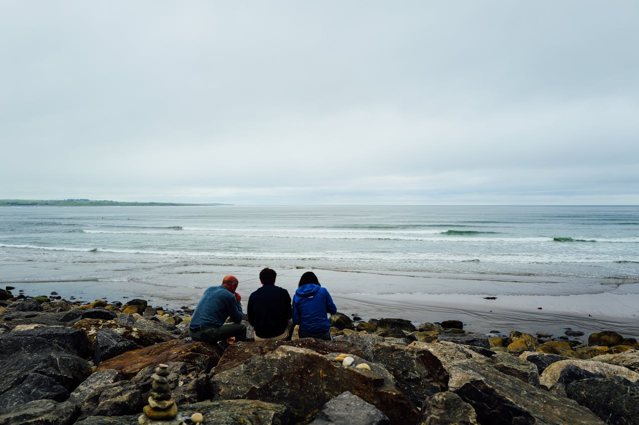 A pair of surfers watching the waves in Strandhill, Ireland.