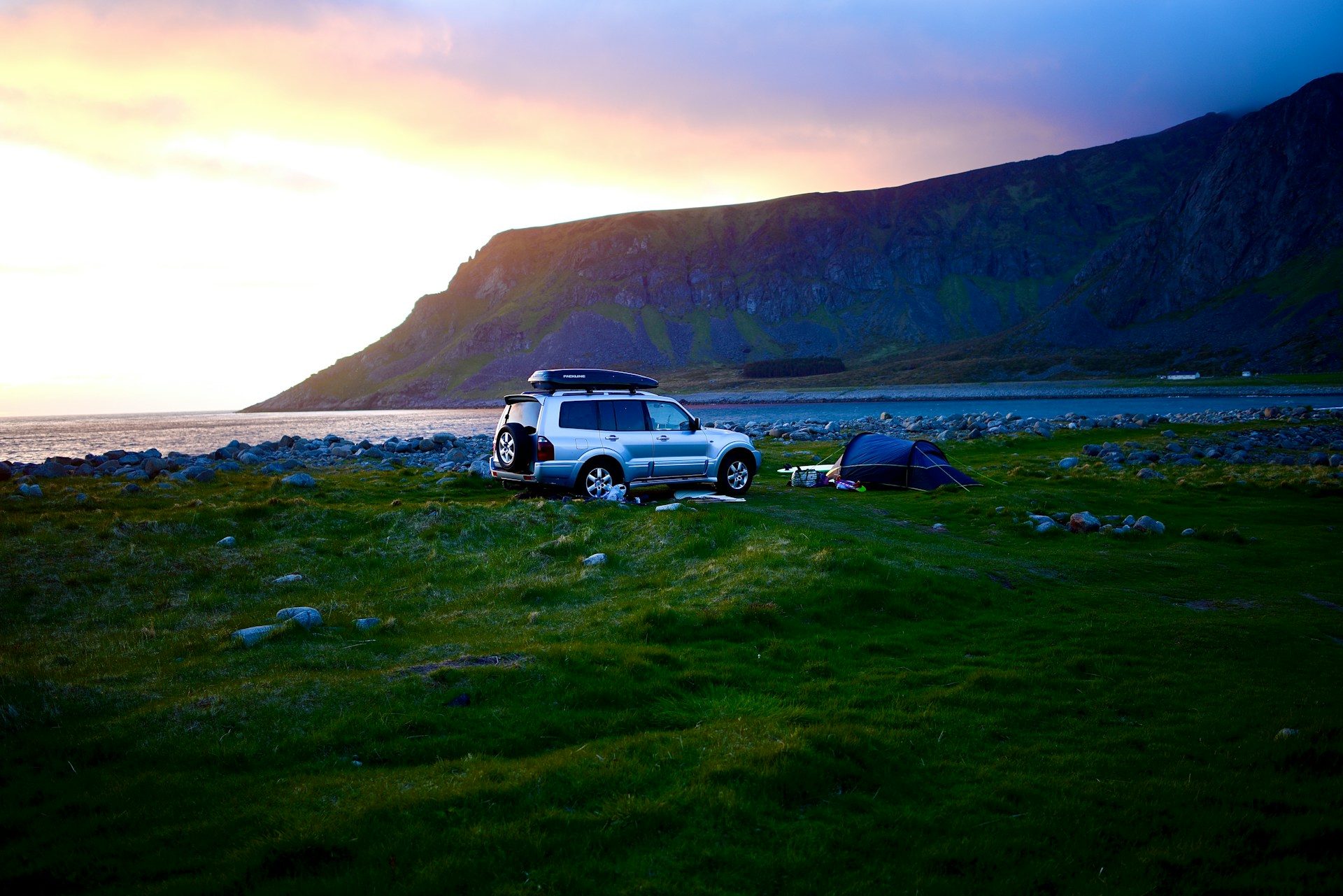 A camper posting up with his car on the Unstad Beach.