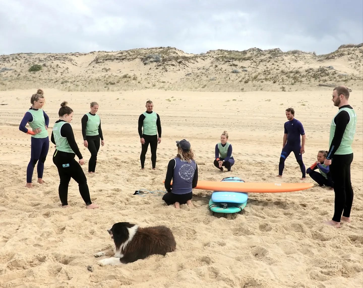 A group of Saint Giron Surf House visitors preparing to hop in the water with a beginner surf lesson.