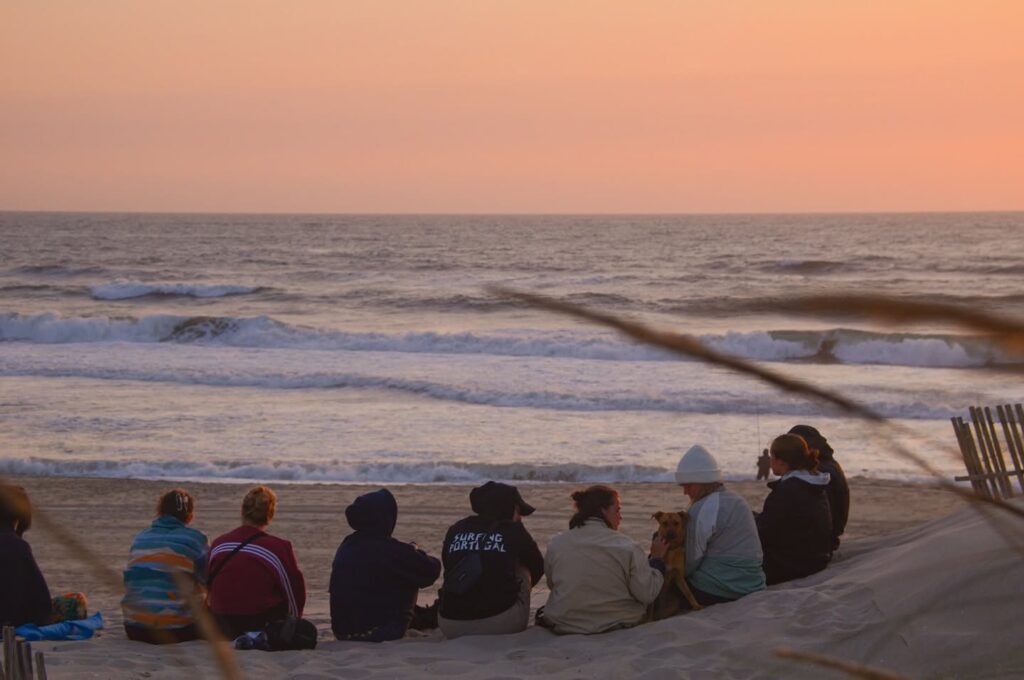 A group of Slide Surf Camp'ers enjoying the sunset at Praia da Vagueira