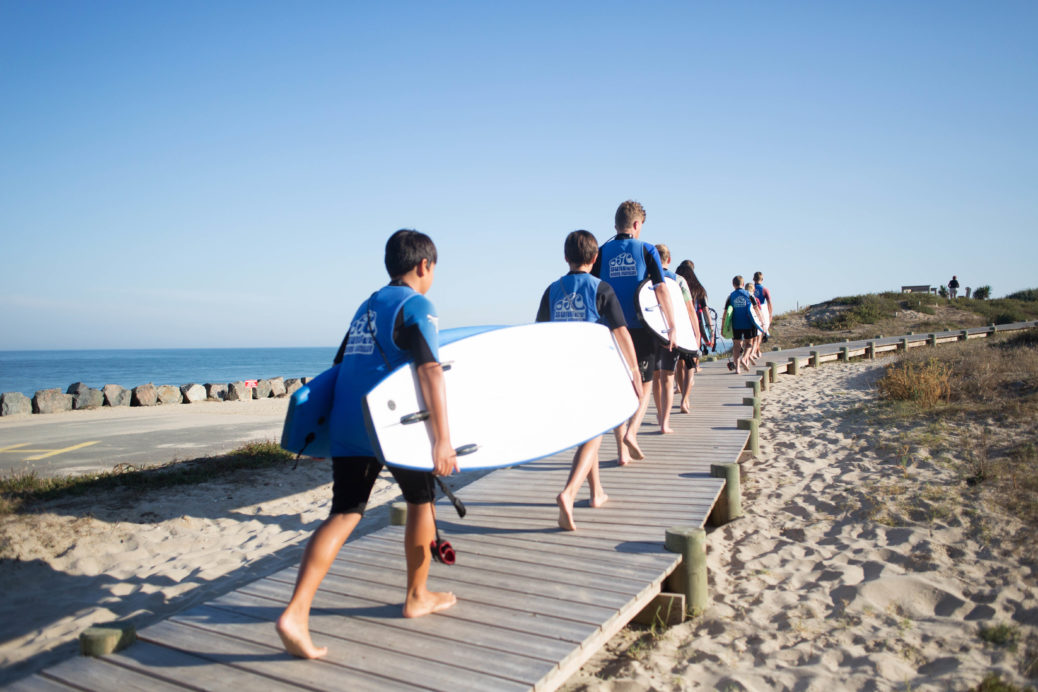 Some surfers heading up the beach post surf lesson.