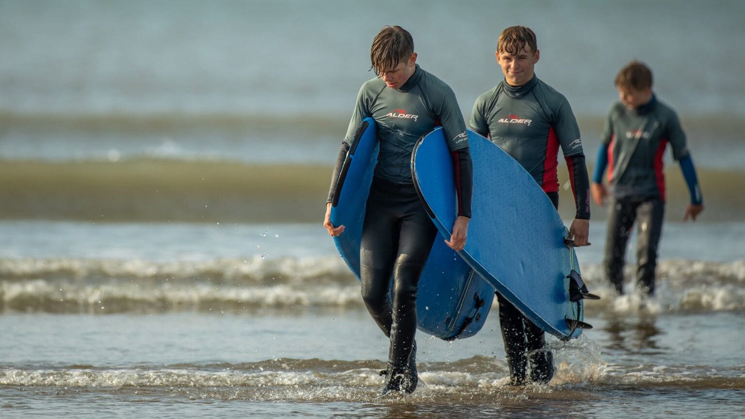 A couple of lads getting out of the water after a surf session with The North Devon Surf School.